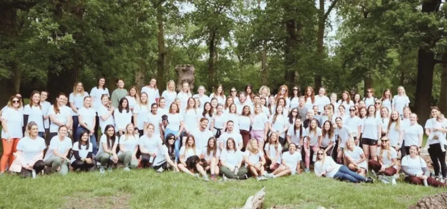 A large Turtle Method community group photographed outdoors
